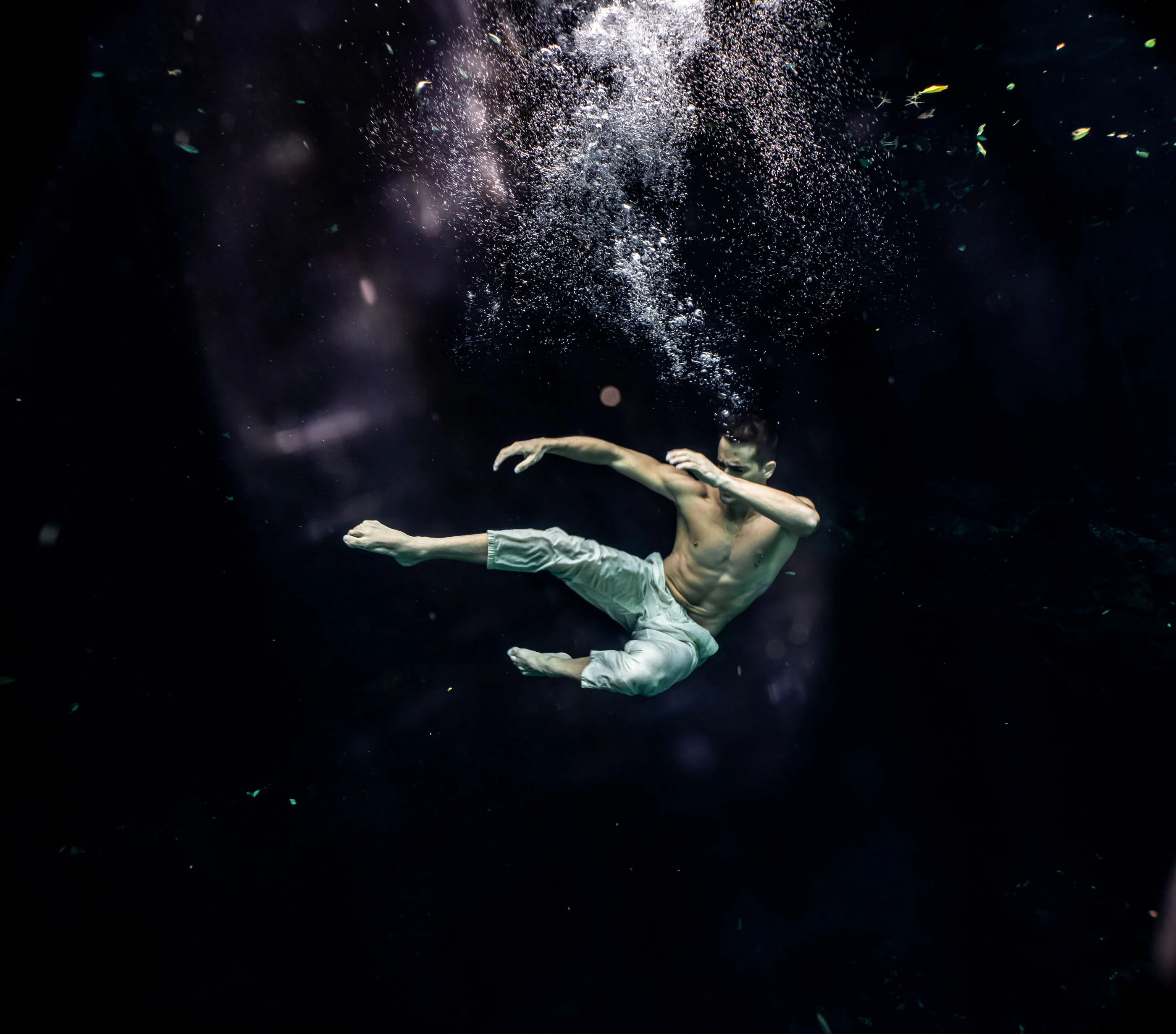 Figure floating in the open water of a Tulum cenote